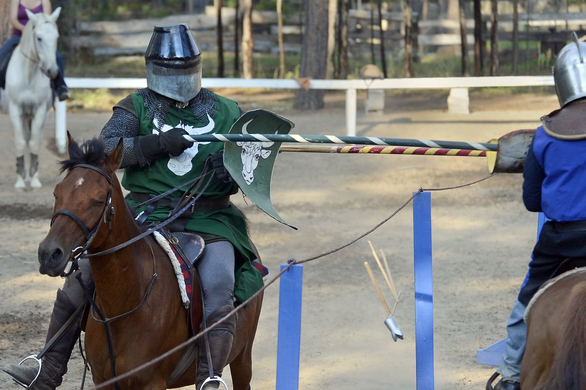 Brian Thornton, left, splinters the tip of his lance as he jousts with Carson Hentges on Friday at the Northwest Renaissance Festival. (Dan Pelle)
