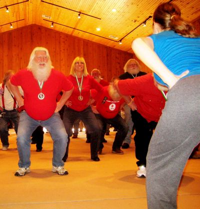 Sabrina Zielinski shows Santas how to stay in shape during a fitness class at the Charles W. Howard Santa Claus School in Midland, Mich.