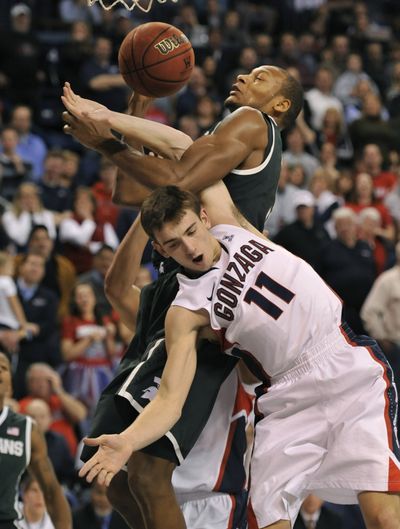 Gonzaga's David Stockton is roughed up in the second half against Michigan State's Adreian Payne. (Dan Pelle)