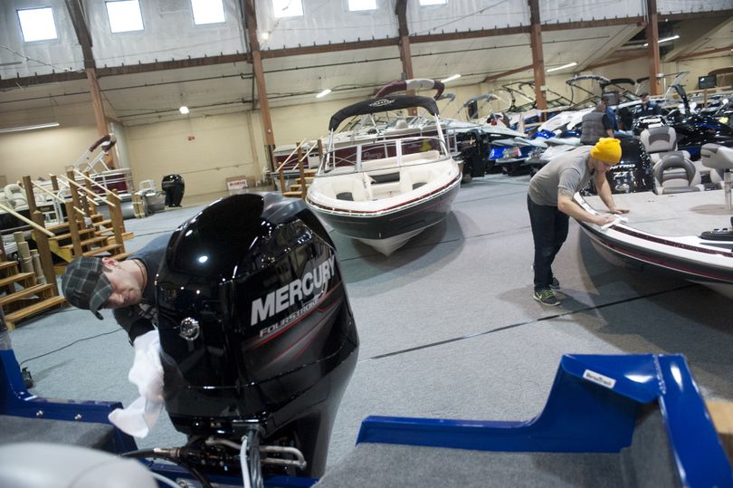 Finishing touches: Tyrone Sprenkel, left, and Josh Gilbert, employees of Boat World, polish boats for the 2013 Spokane National Boat Show at the Spokane County Fair and Expo Center. The 2015 show, sponsored by the Spokane Yacht Club, starts Feb. 4. (Tyler Tjomsland)