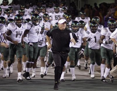 This Sept. 25, 2010, file photo shows Oregon coach  Chip  Kelly leading his team onto the field to face Arizona State in an NCAA football game, in Tempe, Ariz.  Kelly has been voted AP Coach of the Year, Tuesday, Dec. 21, 2010, after leading the second-ranked Ducks to an undefeated record and a spot in the BCS national championship game in just his second season as the team's leader. ( (AP Photo/Paul Connors, File))