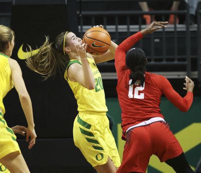 Oregon's Sabrina Ionescu grabs a rebound to complete her triple-double at the end of third quarter on Sunday in Eugene. (Chris Pietsch / Associated Press)