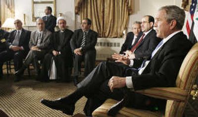 
President Bush, right, makes a statement to reporters as Iraqi Prime Minister Nouri al-Maliki, second from right, and and other Iraqi officials look on during their meeting at the U.N. Tuesday. Associated Press
 (Associated Press / The Spokesman-Review)