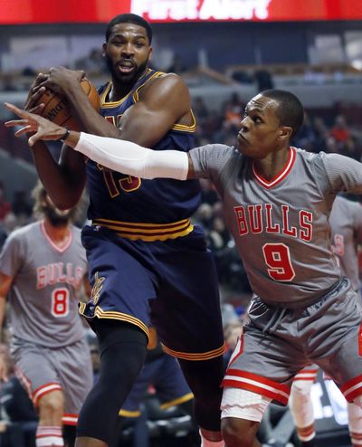 Cleveland Cavaliers forward Tristan Thompson pulls in a rebound next to Chicago Bulls guard Rajon Rondo during the first half of an NBA basketball game Friday, Dec. 2, 2016, in Chicago. (Nam Y. Huh / Associated Press)