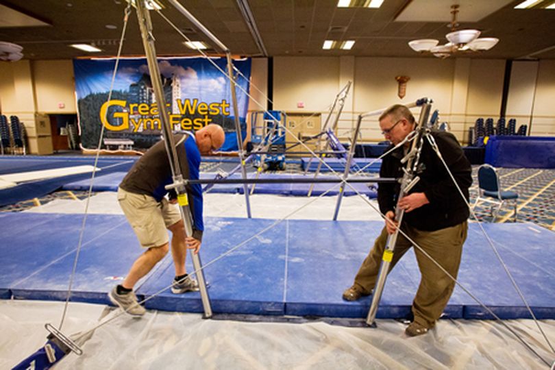 Jim Tighe, with Tighe Gym Sales, left, works with Scott Wolf, of the host club Inland Empire Gymnastics, to adjust the parallel bars Wednesday while making preparations for this weekend's Great West Gym Fest at the Coeur d'Alene Resort. (Shawn Gust/press)