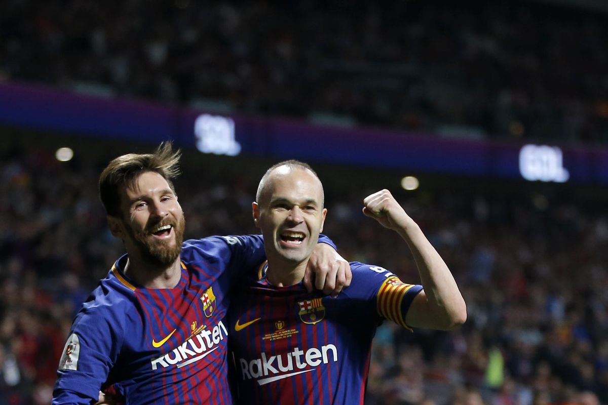 Barcelona’s Andres Iniesta, right, celebrates withLionel Messi after scoring his side’s fourth goal during the Copa del Rey final soccer match between Barcelona and Sevilla at the Wanda Metropolitano stadium in Madrid, Spain, Saturday, April 21, 2018. (Paul White / Associated Press)
