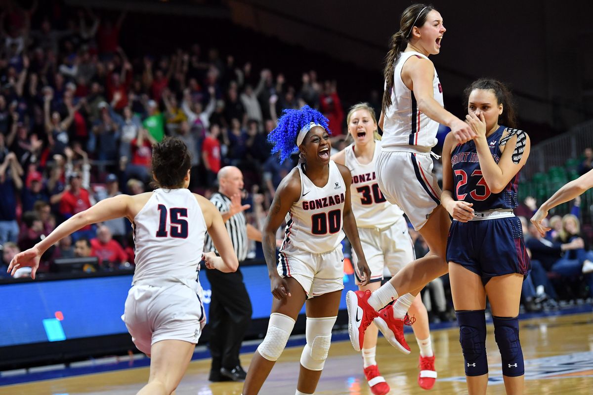 Gonzaga Bulldogs forward Zykera Rice (00) reacts with guard Jessie Loera (15), guard Chandler Smith (30) and forward Jenn Wirth (3), after she hit a shot in the final seconds of a second overtime period to defeat the Saint Mary