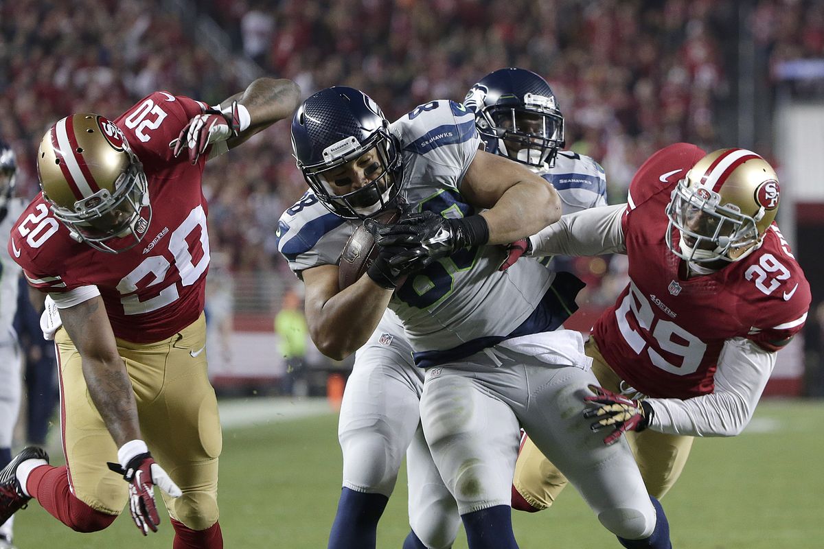 Seahawks tight end Tony Moeaki is tackled by 49ers’ Perrish Cox, left, and Chris Culliver at the end of a 63-yard catch-and-run. (Associated Press)