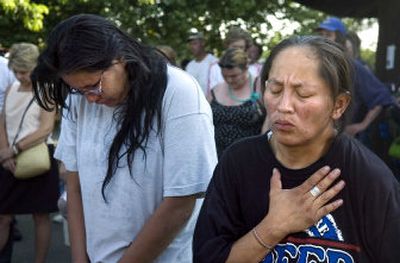 
Harriet Iness, right, and Penny Blackburn remember their friend Doug Dawson during a memorial for the homeless man in Riverfront Park on Tuesday. Dawson died Monday from burn injuries suffered when he was set on fire in his wheelchair. 
 (Holly Pickett / The Spokesman-Review)