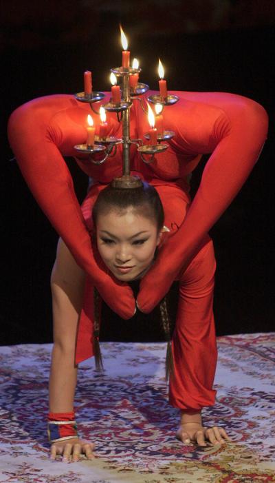 ORG XMIT: ANJ107 A Chinese acrobat performs during the inaugural ceremony of China Culture Show in Islamabad, Pakistan, Monday, Sept. 28, 2009. The show organized by Pakistan Ministry of Culture in collaboration with the Chinese Embassy to celebrate China's 60th anniversary. (AP Photo/Anjum Naveed) (Anjum Naveed / The Spokesman-Review)