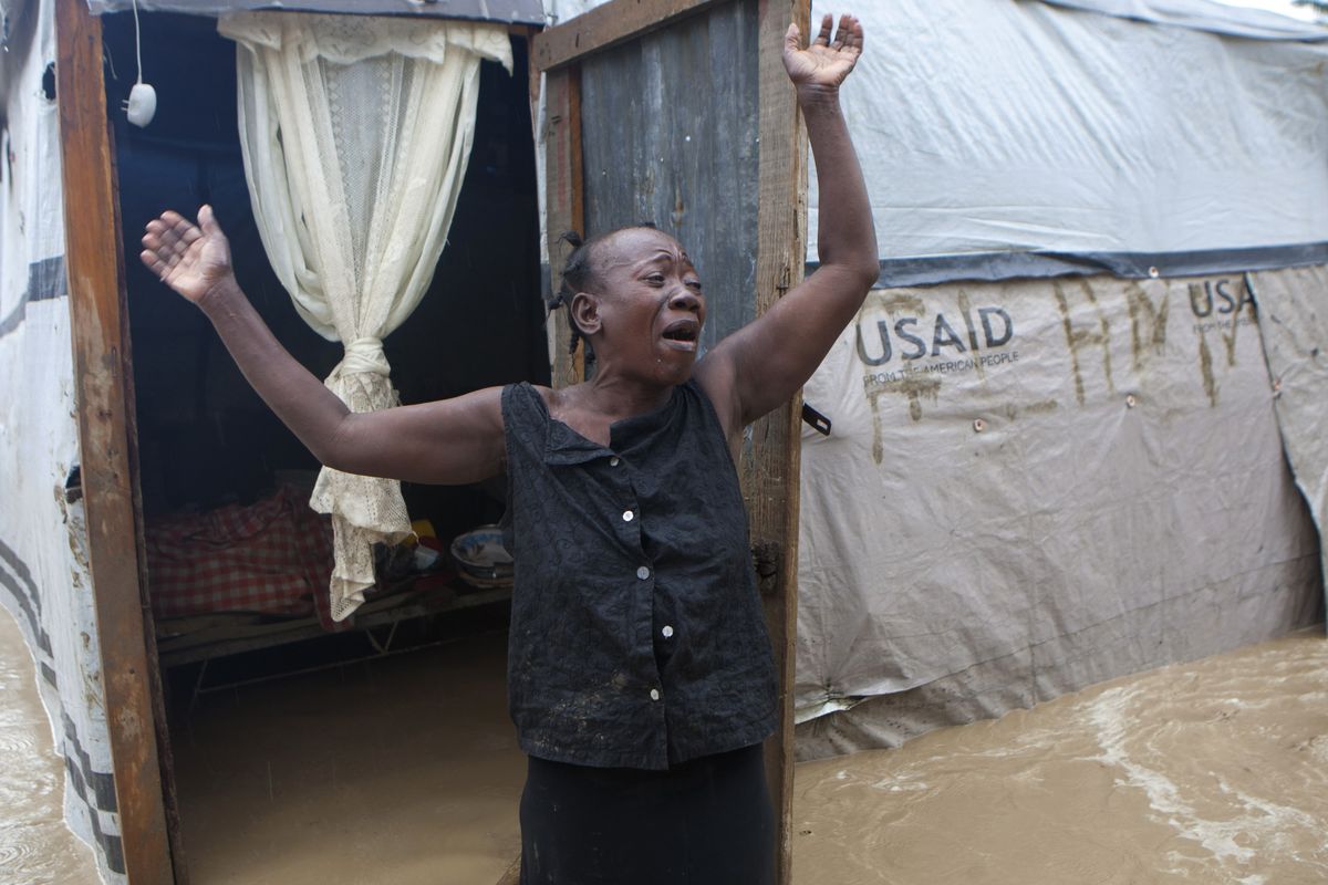 A woman cries out in front of her flooded house caused by heavy rains from Hurricane Sandy in Port-au-Prince, Haiti, Thursday, Oct. 25, 2012. Hurricane Sandy rumbled across mountainous eastern Cuba and headed toward the Bahamas on Thursday as a Category 2 storm, bringing heavy rains and blistering winds. (Dieu Chery / Associated Press)
