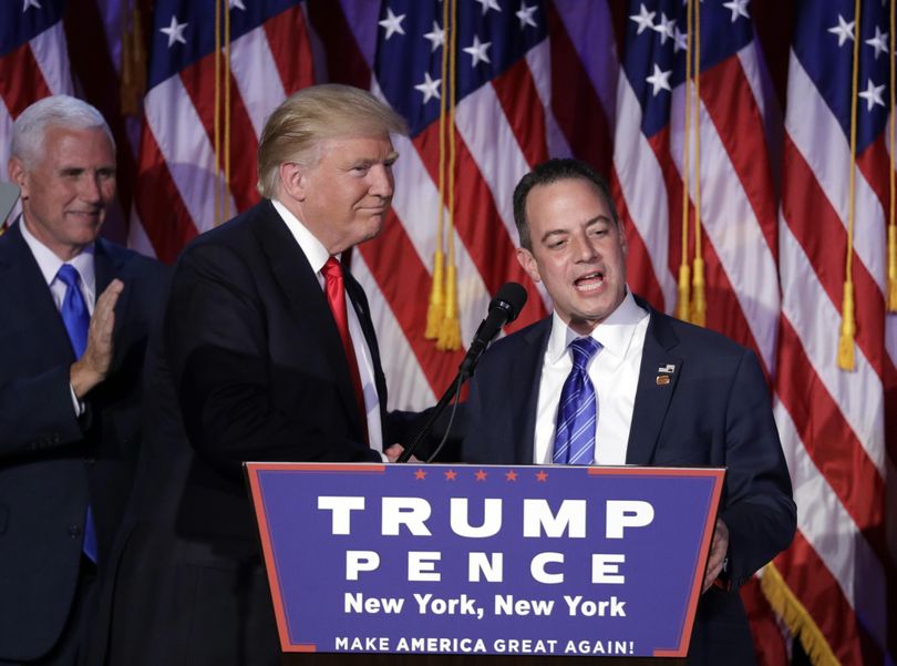Reince Priebus, chair of the Republican National Committee, right, speaks as President-elect Donald Trump gives his acceptance speech during his election night rally, Wednesday, Nov. 9, 2016, in New York. (John Locher / Associated Press)