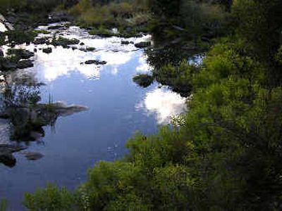
The still pool below Meyer's Falls reflects blue sky and white clouds above.
 (Nancy Lemons/Special to Travel / The Spokesman-Review)