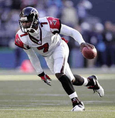 
Atlanta Falcons quarterback Michael Vick changes the dynamics of the game with his ability to freelance on the field. 
 (Associated Press / The Spokesman-Review)