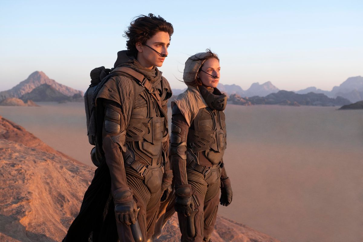 This image released by Warner Bros. Pictures shows Timothee Chalamet, left, and Rebecca Ferguson in a scene from "Dune."  (Chia Bella James)