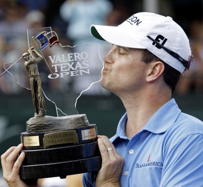 Zach Johnson collects the Texas Open trophy for the second straight year. (Associated Press / The Spokesman-Review)