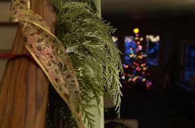 
Cedar garland wrapped around a wooden banister graces a North Idaho home. 
 (Brian Plonka / The Spokesman-Review)