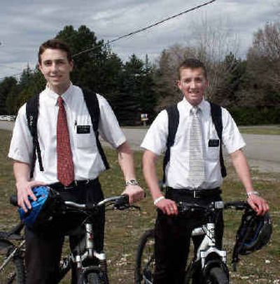 
Elder Collin Thompson, left, and Mike Kettle spread the Mormon word on mountain bikes in Coeur d'Alene. 
 (Mike Kincaid/Handle Extra / The Spokesman-Review)