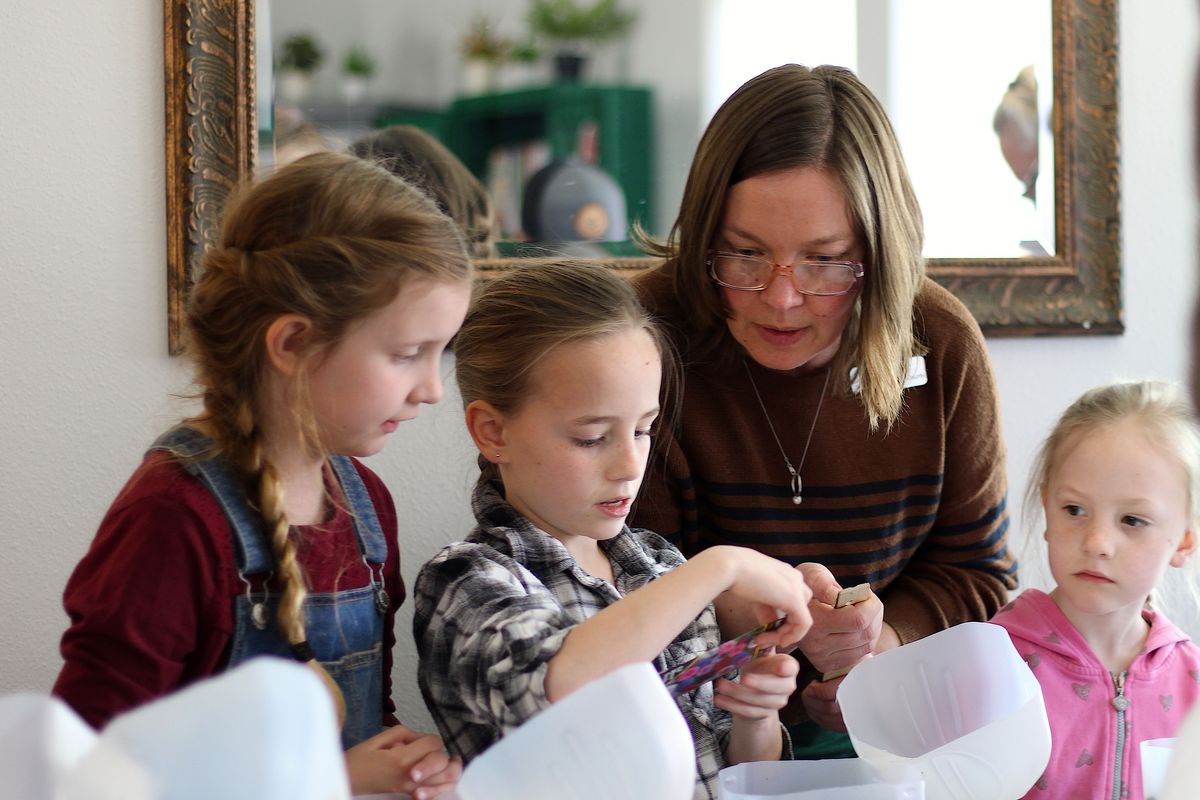 Ella Kerner, branch lead for Hunters and Colville libraries, helps young learners with their mini greenhouses. The rural library is one of seven at risk of cuts to services and hours if an operations levy doesn’t pass this April. (Monica Carillo-Casas/The Spokesman-Review)