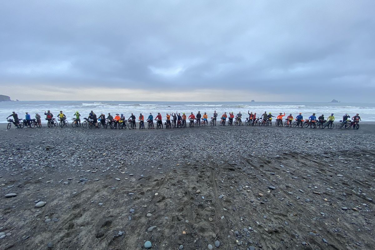 A group of 42 cyclists dipped its back tires into the Pacific Ocean at La Push, Washington, on May 23, posed for a photo and then pedaled east on the Cross-Washington Mountain Bike Route.  (Courtesy of Troy Hopwood)