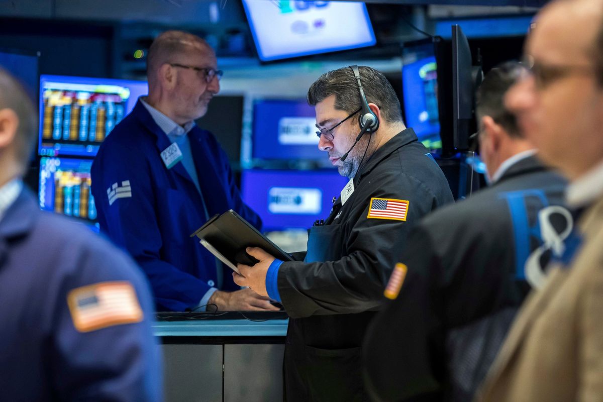 Trader Michael Capolino, right center, works on the floor of the New York Stock Exchange on April 8, 2022.  (Associated Press )