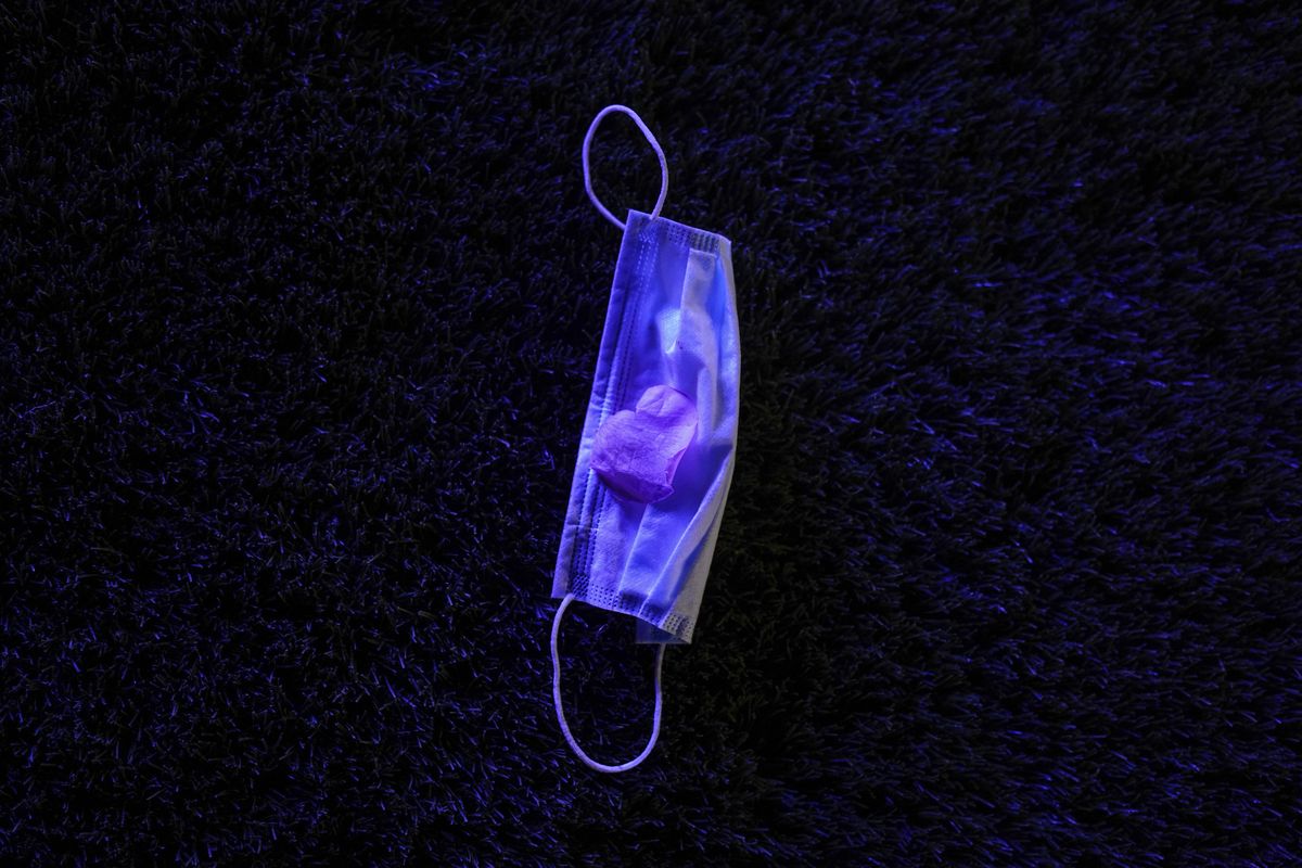 A surgical mask lies on the ground during a prom held at the Grace Gardens Event Center in El Paso, Texas on Friday, May 7, 2021. Around 2,000 attended the outdoor event at the private venue after local school districts announced they would not host proms this year. Tickets cost $45.  (Paul Ratje)