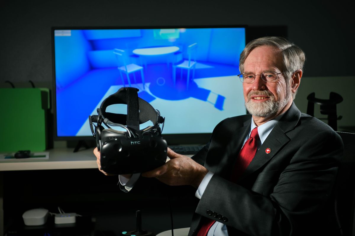 Dr. Ken Isaacs is director of the Steve Gleason Institute for Neuroscience in Spokane. Here he demonstrates a WSU Virtual Wheelchair Training Simulator that helps teach patients to use a motorized chair.  (DAN PELLE/THE SPOKESMAN-REVIEW)