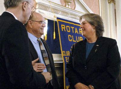 
Spokane County Commission candidates Phil Harris, center, and Bonnie Mager  talk with Robin Corkery  at a Rotary Club gathering at the Spokane Club in September.  
 (Dan Pelle / The Spokesman-Review)