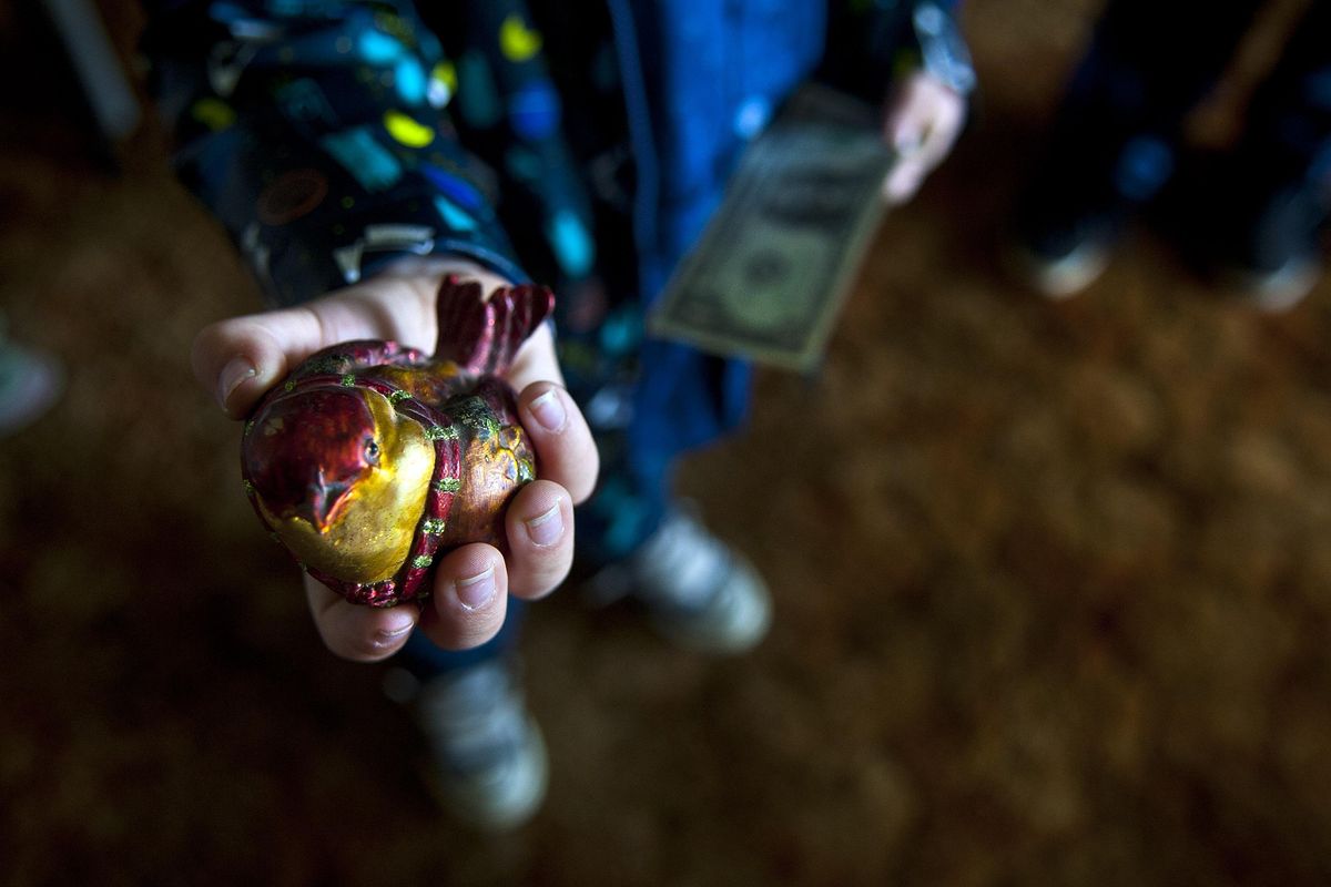 Five-year-old Maddox Bieber bought this bird for 25 cents during an estate sale in Spokane Valley on Sunday, April 8, 2018. (Kathy Plonka / The Spokesman-Review)