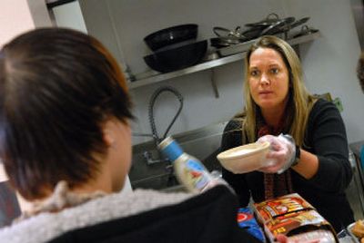 
Youth coordinator Laurel Kelley serves lunch  last week at Crosswalk, a shelter for teens  in downtown Spokane. 
 (Brian Plonka / The Spokesman-Review)