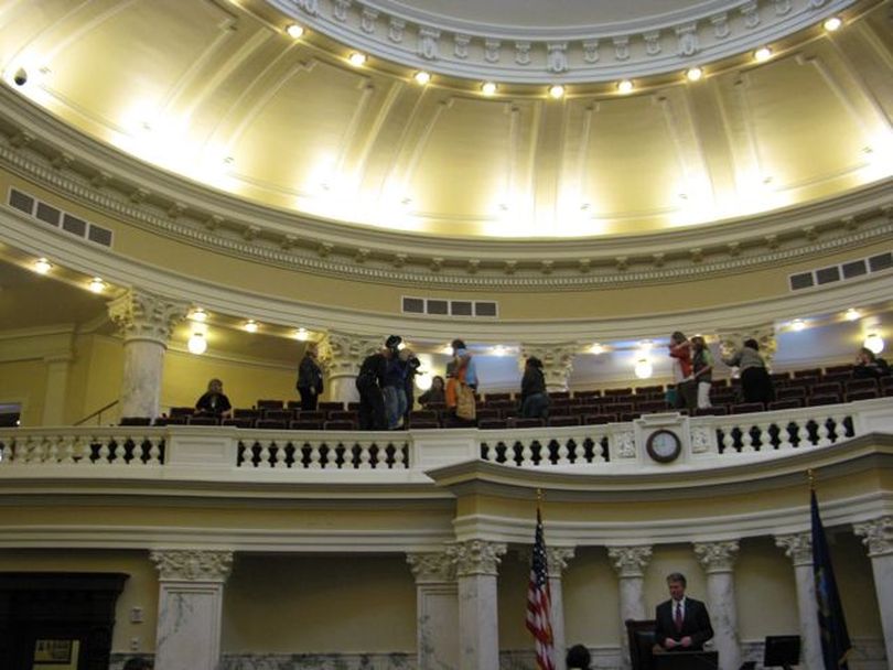 Occupy Boise supporters are escorted from the Senate Gallery on Thursday by state police officers; the Senate was placed at ease after it was disrupted by a scream from the gallery of 