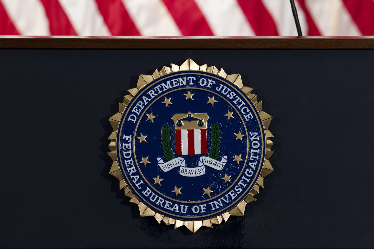 FILE - In this June 14, 2018, file photo, the FBI seal is seen before a news conference at FBI headquarters in Washington. A former FBI lawyer was sentenced to probation for altering a document the Justice Department relied on during its surveillance of a Donald Trump aide during the Russia investigation.  (Jose Luis Magana)
