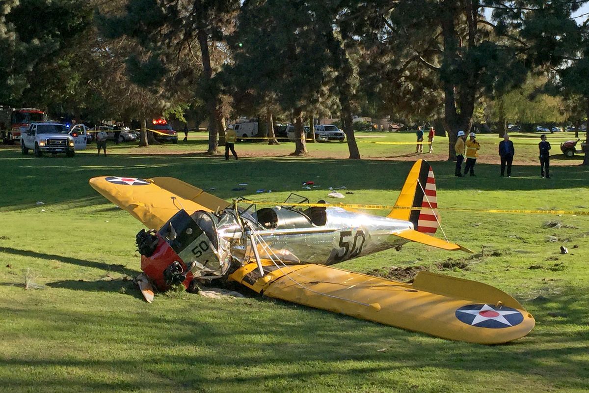 A plane piloted by actor Harrison Ford lies where it crash-landed on Penmar Golf Course in Santa Monica, Calif., on Thursday. The course is near the Santa Monica Municipal Airport, just west of a runway. (Associated Press)