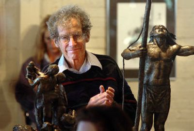 
Surrounded by artwork on display, attorney Scott Reed applauds from the audience during the dedication ceremony for the new Human Rights Education Institute on Saturday in Coeur d'Alene.  Reed's wife serves on the board of the institute. 
 (Jesse Tinsley / The Spokesman-Review)