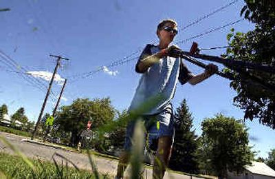 
Joe Myers, 13, mows his front lawn on Broadway in Spokane Valley. 
 (Liz Kishimoto / The Spokesman-Review)