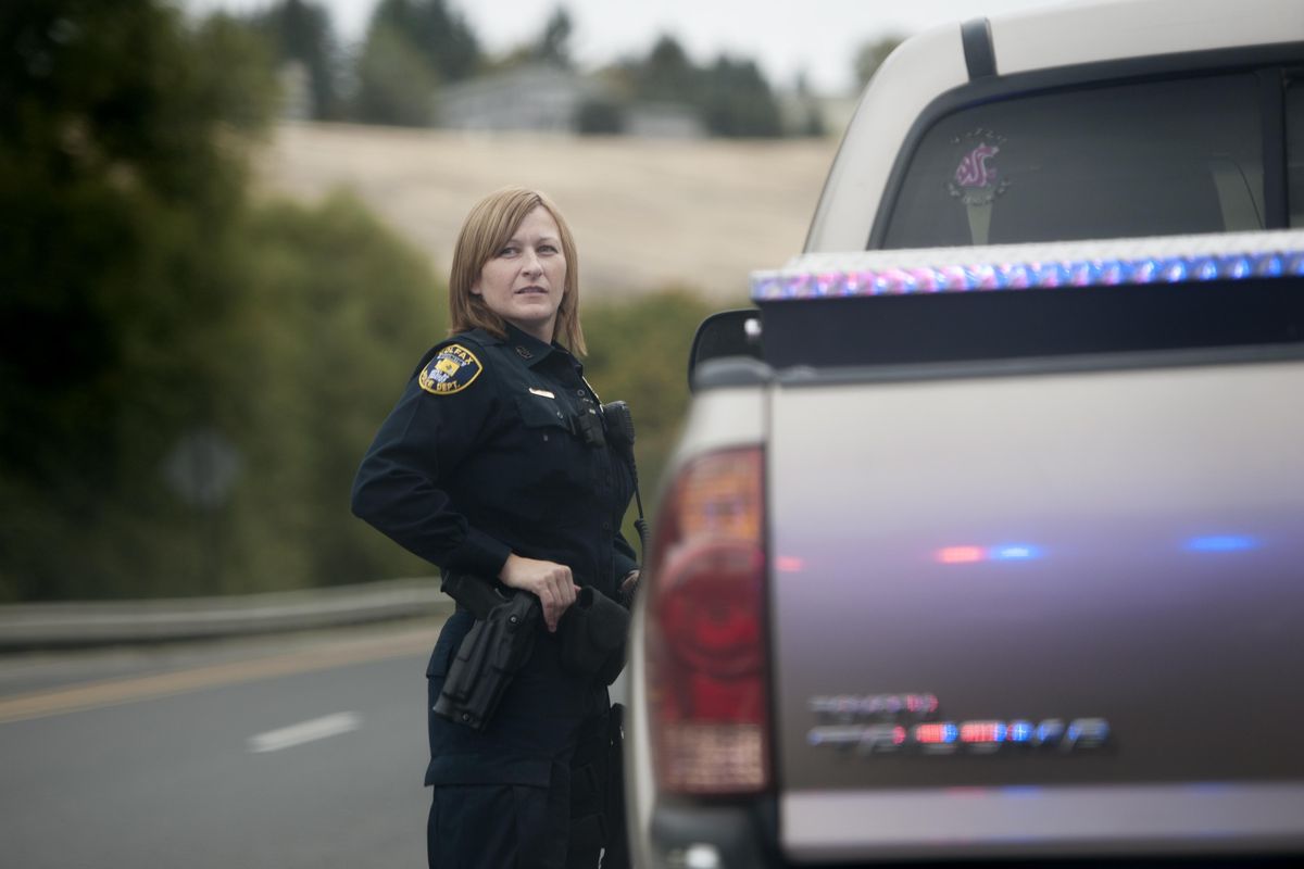 Colfax police officer Jaelene Bryan pauses after she pulled a motorist over for failure to signal when changing lanes, as the motorist was en route to a WSU game on Saturday, Sep 17, 2016, in Colfax, Wash. (Tyler Tjomsland / The Spokesman-Review)
