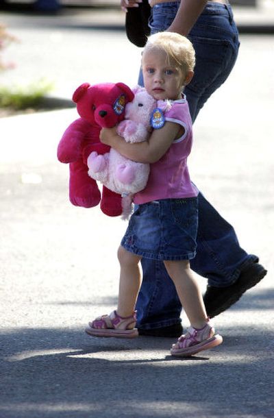 
An unidentified girl carries teddy bears into Kootenai Medical Center in Coeur d'Alene. Dozens of children and families dropped off gifts, cards and balloons for Shasta Groene. 
 (Jesse Tinsley / The Spokesman-Review)