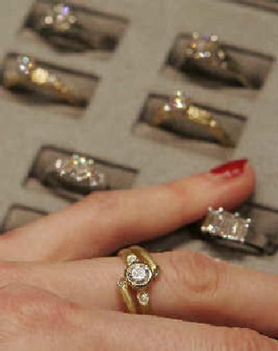 
A woman tries on a diamond ring at the Clay Pot jewelry store in New York. This holiday season some diamond retailers say they are seeing heightened consumer concern about conflict diamonds, the gems mined in war zones that are sold to fund armed conflict. 
 (Associated Press / The Spokesman-Review)