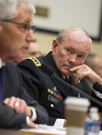 Joint Chiefs Chairman Gen. Martin Dempsey, at right, listens as Defense Secretary Chuck Hagel testifies Thursday before the House Armed Services Committee. (Associated Press)