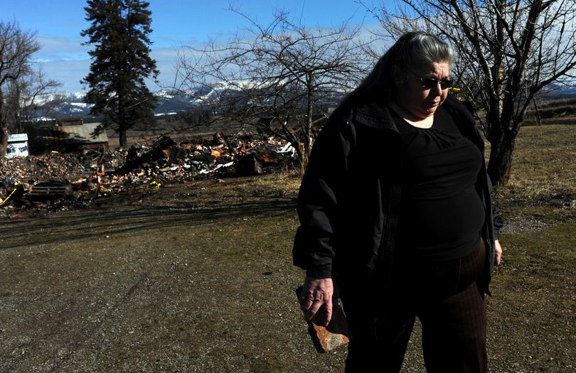 “I’ve lost my childhood home,” said Plummer, Idaho, resident Mariane Nomee, as she retrieved a brick from the burned rubble of the former Mary Immaculate School in DeSmet on Thursday. Nomee lived most of her childhood at the boarding school. (Kathy Plonka)