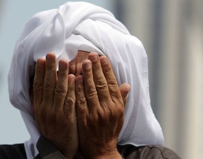 An anti-government protester prays Monday in Manama, Bahrain’s Pearl Square, center of the monthlong uprising. (Associated Press)