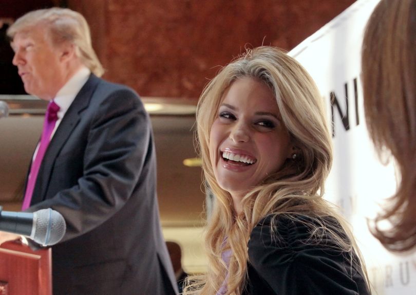 ORG XMIT: NYR205 Miss California USA, Carrie Prejean, reacts as Donald Trump, left, speaks during a news conference in New York, Tuesday May 12, 2009.  Trump, who owns the Miss USA pageant, says Prejean can retain her Miss California USA crown after she caused a stir expressing opposition to gay marriage and posing in racy photographs.  (AP Photo/Bebeto Matthews) (Bebeto Matthews / The Spokesman-Review)