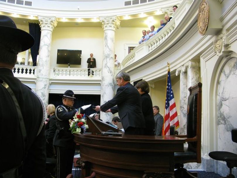 House Speaker Lawerence Denney presents an honor guard with the flag that will fly above the chamber, signifying that the Legislature is in session for 2010. (Betsy Russell)