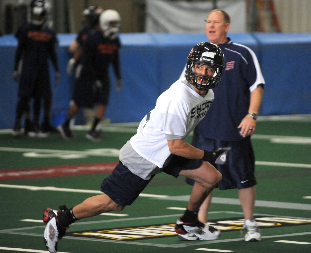 Spokane Shock receiver, Aiona Key, runs a route in front of offensive coach, Fred Biletnikoff Jr., on the first day of practice on Saturday, Feb. 19, 2011, at the Shock practice facility in Spokane Valley. (Jesse Tinsley / The Spokesman-Review)