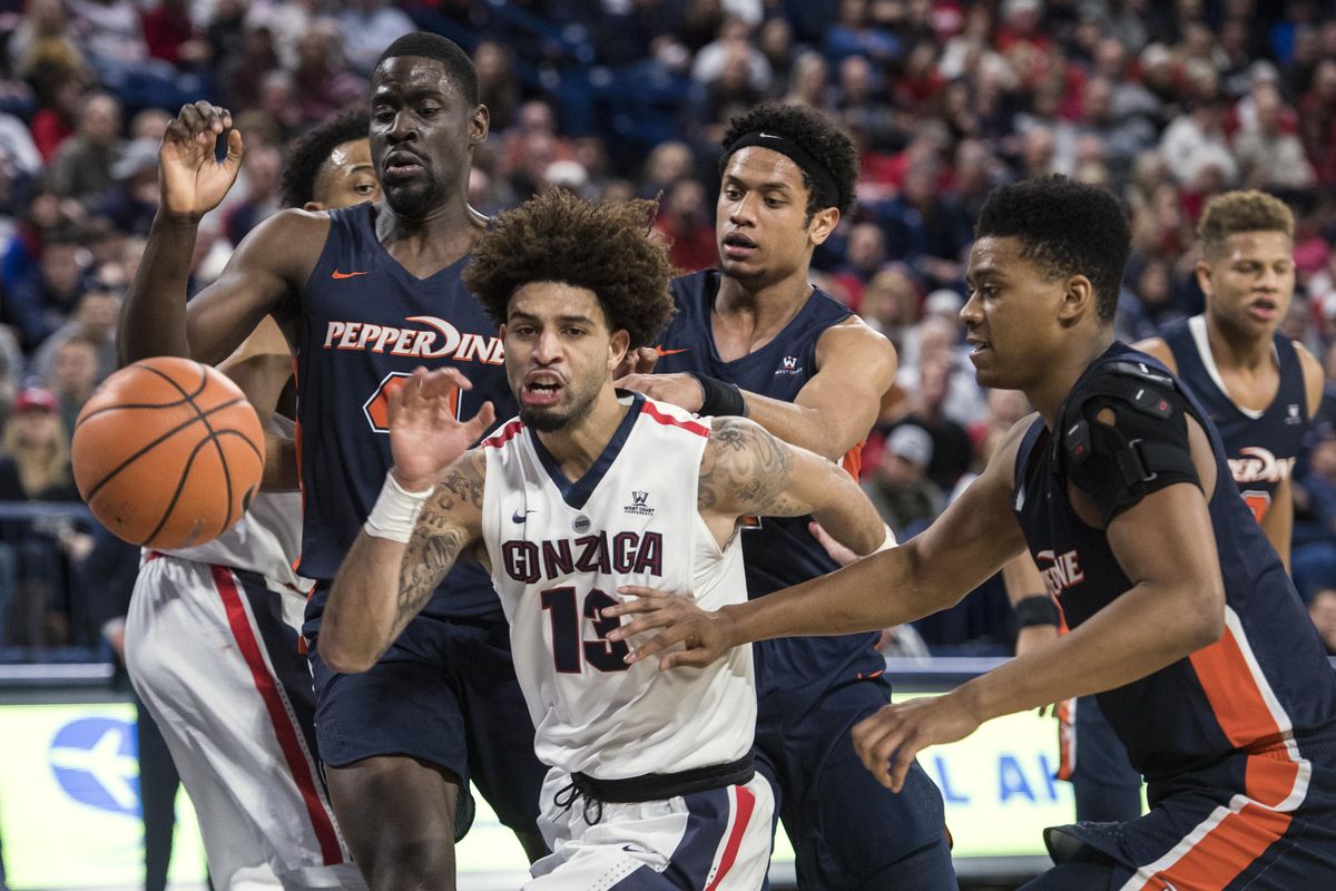 Gonzaga guard Josh Perkins chases after a loose ball against Pepperdine players Matthew Atewe, Trae Berhow and Eric Cooper, Saturday, Feb. 17, 2018, in the McCarthey Athletic Center. (Dan Pelle / The Spokesman-Review)