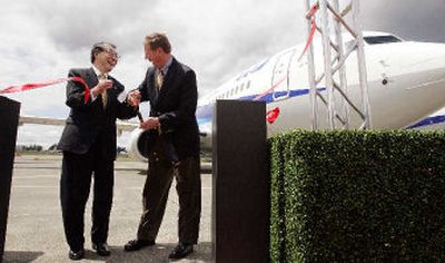 
Boeing Co. president and CEO Alan Mulally, right, shares a laugh with All Nippon Airways president and CEO Mineo Yamamoto during a delivery ceremony of three Boeing aircraft to ANA at Boeing's Everett, Wash., plant on Wednesday. 
 (Associated Press / The Spokesman-Review)