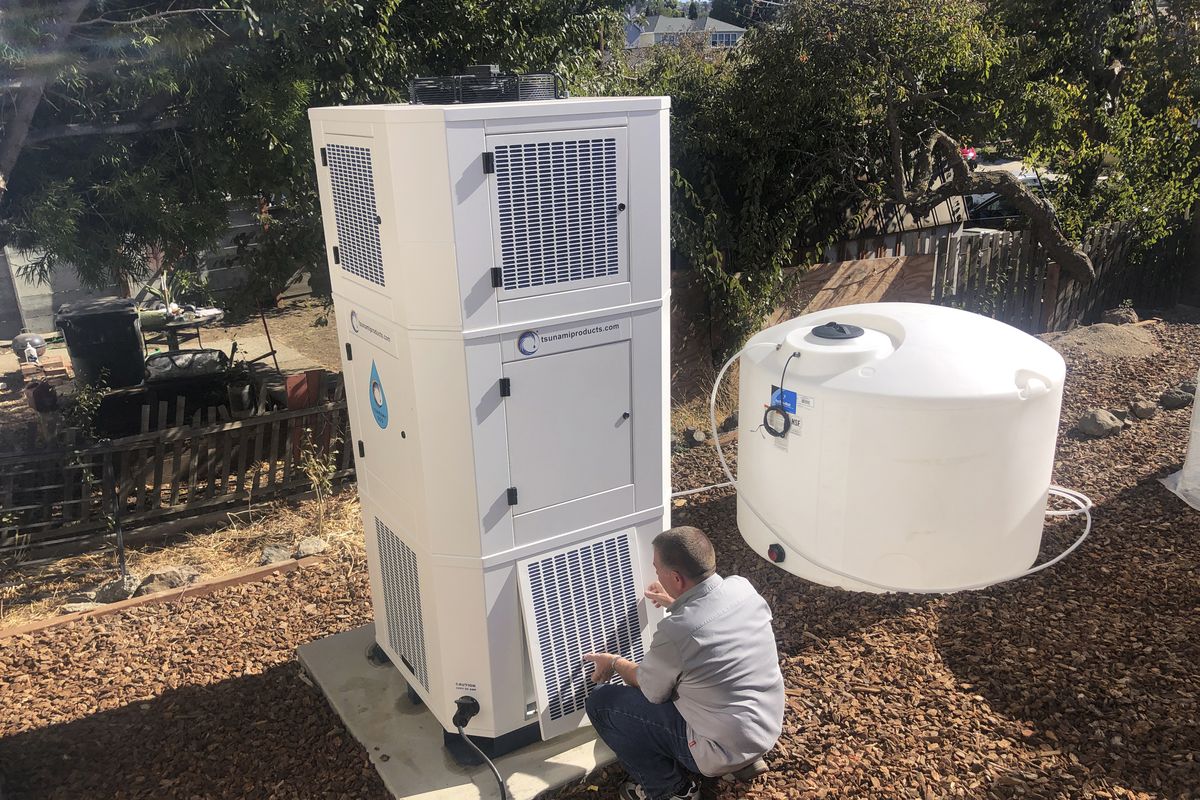 Ted Bowman, design engineer with Tsunami Products, installs a unit in homeowner Don Johnson