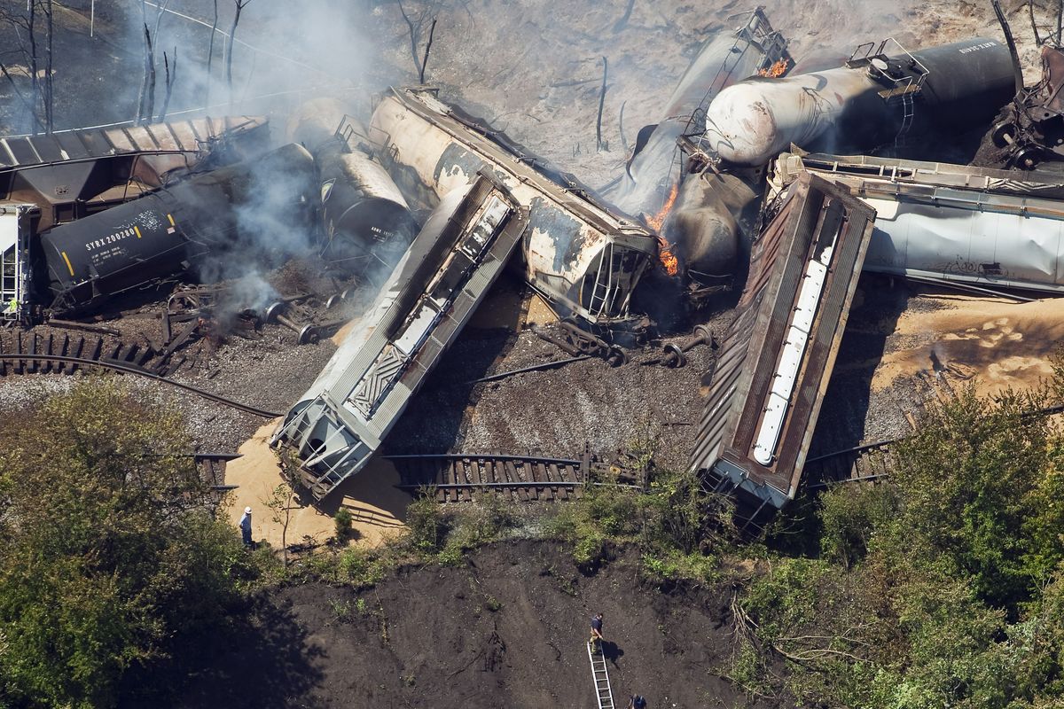 FILE - This July 11, 2012 aerial file photo, a freight train is seen after an early morning derailment in Columbus, Ohio. Part of the freight train carrying ethanol derailed and caught fire, shooting flames skyward into the darkness and prompting the evacuation of a mile-wide area as firefighters and hazardous materials crews monitored the blaze. For two decades, one of the nation�s most common types of rail tanker, known as a DOT-111, a workhorse of the American rail fleet, has been allowed to haul hazardous liquids from coast to coast even though transportation officials were aware of a dangerous design flaw that almost guarantees the car will tear open in an accident. The rail and chemical industries have committed to a safer design for new tankers, but they do not want to modify tens of thousands of existing cars. That�s despite a spike in the number of accidents. (Eamon Queeney / The Columbus Dispatch)