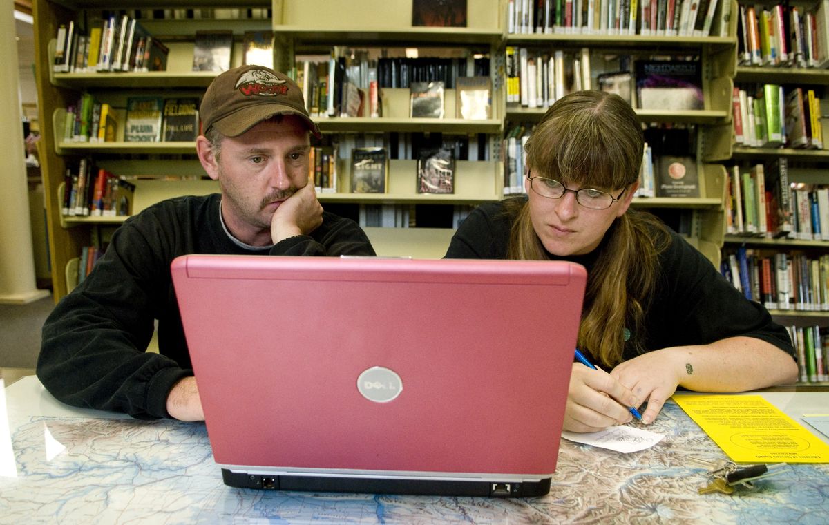 At the Colville Public Library, Craig Riley and Heather Mooneyham, who do not have Internet access at home, use the library’s high-speed wireless connection to search for jobs on their laptop. In Stevens County, almost a quarter of all households have no Internet access. (Colin Mulvany / The Spokesman-Review)