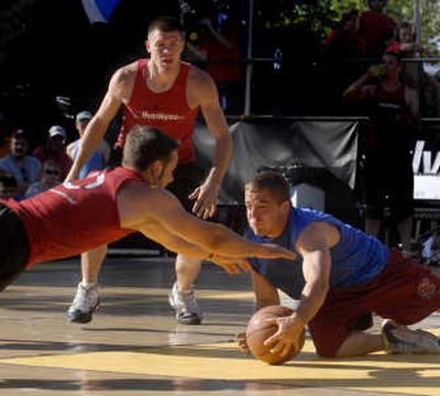 
Elite Under 6-feet MVP Spencer Bishop of Associated Messenger beats Joel Ryman of MyThankYou.com to a loose ball en route to second straight title. 
 (J. Bart Rayniak / The Spokesman-Review)